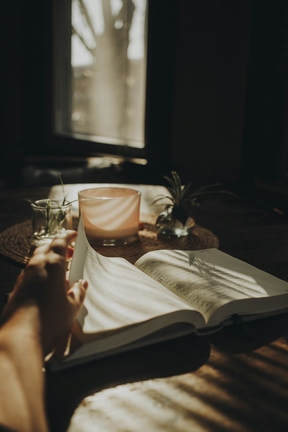 a person sitting at a table with an open book