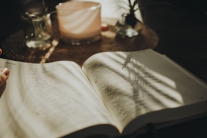 a person is reading a book on a table