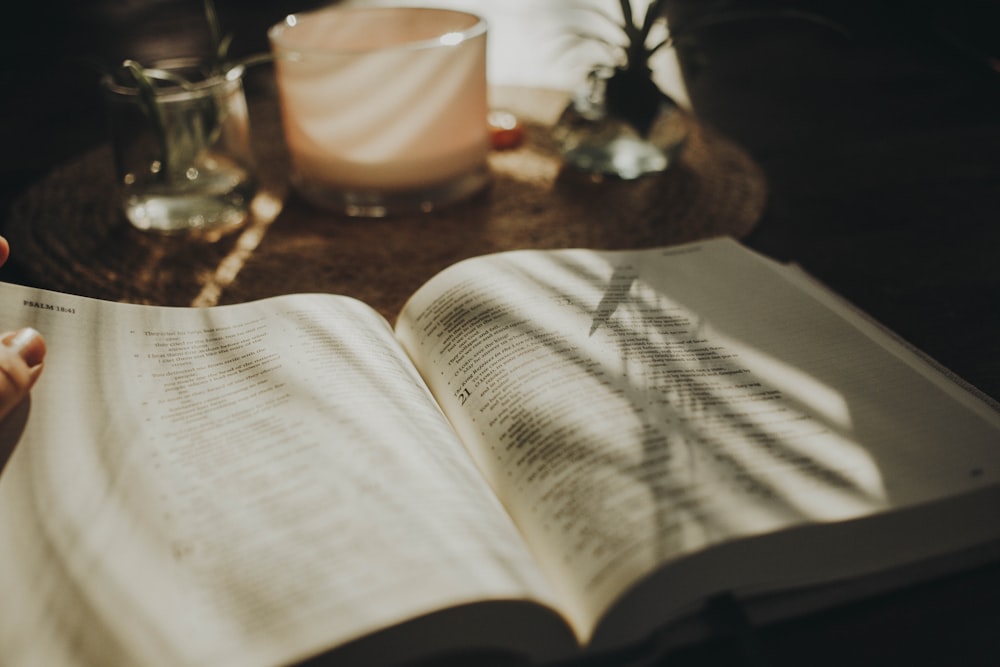 a person is reading a book on a table