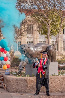 a man standing in front of a statue of a lion