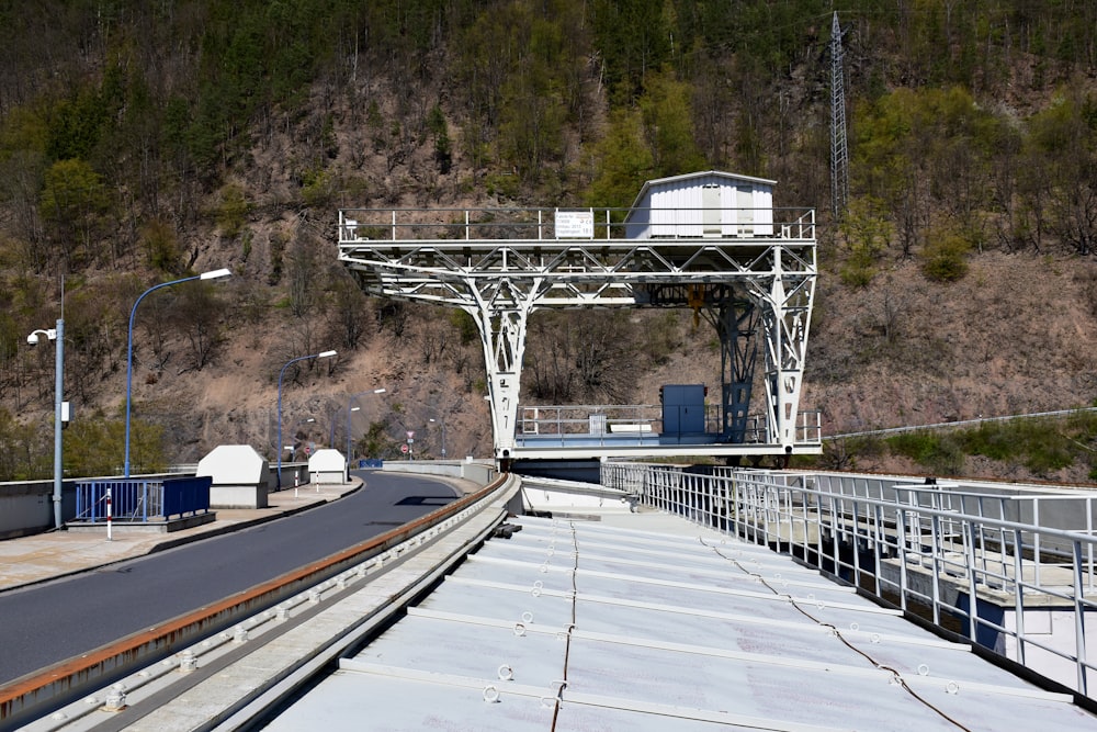 a train traveling over a bridge next to a mountain