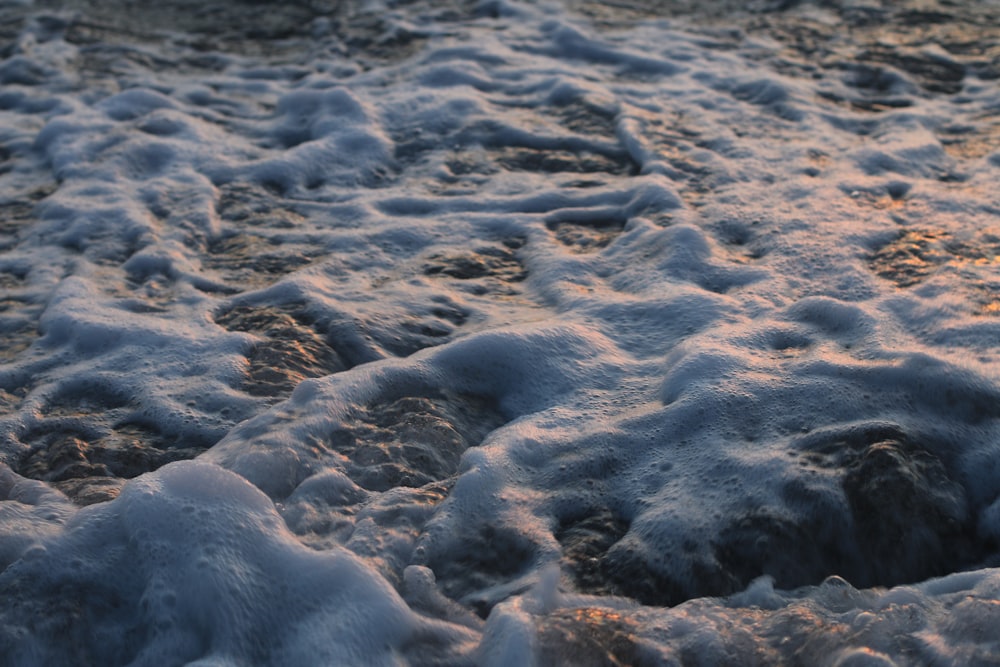 a beach covered in snow at sunset