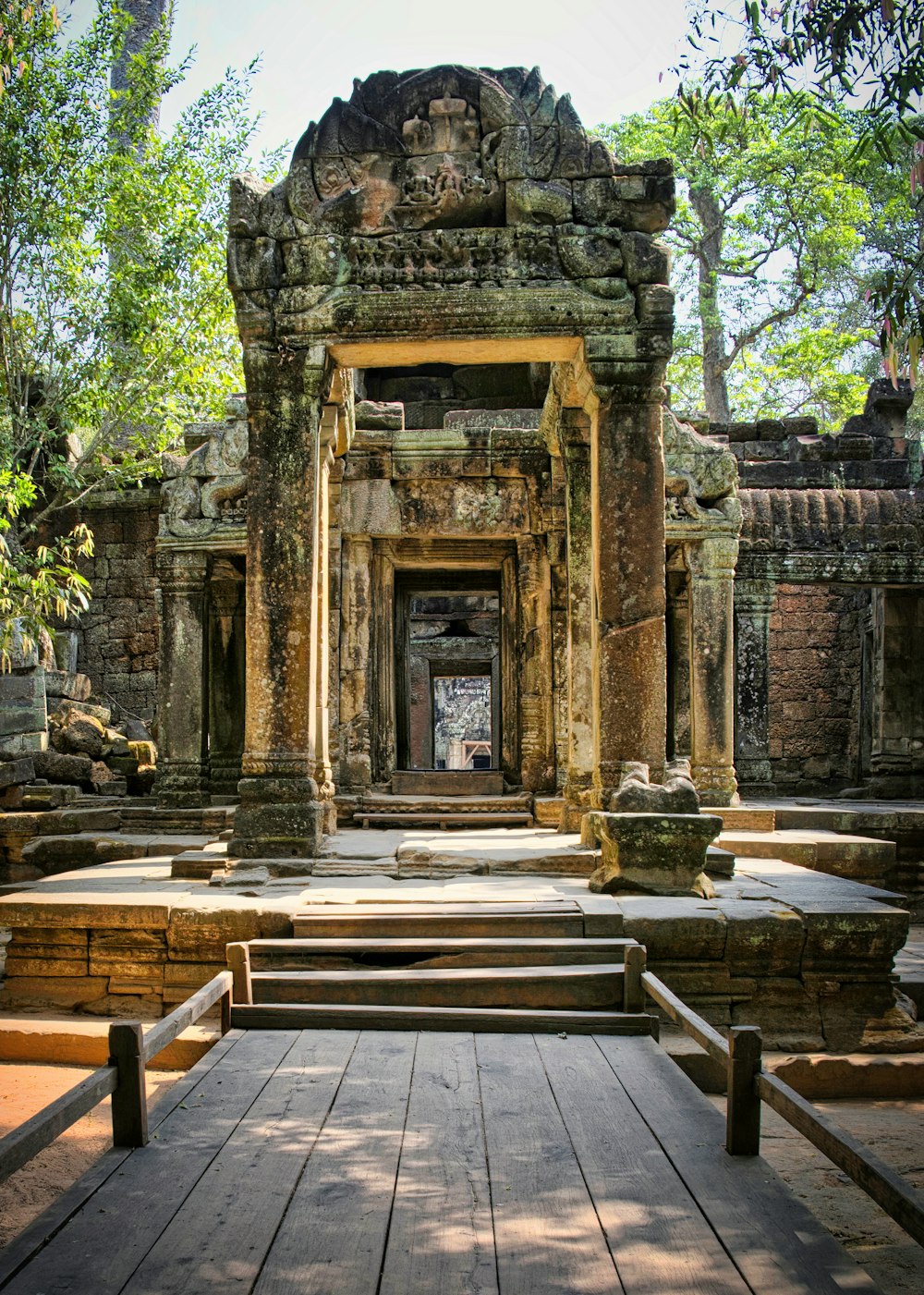 a wooden walkway leading to a doorway in a temple