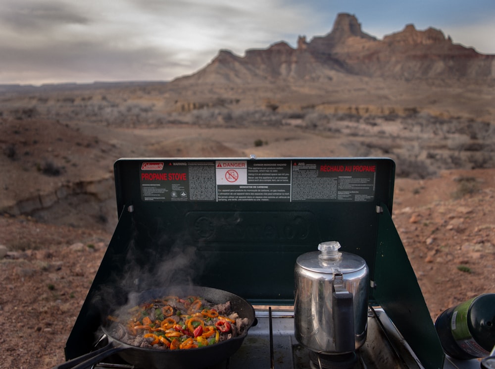 a stove top with a pan of food on it