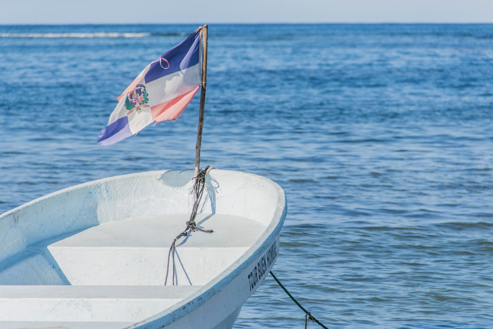 a small boat with a flag on the front of it