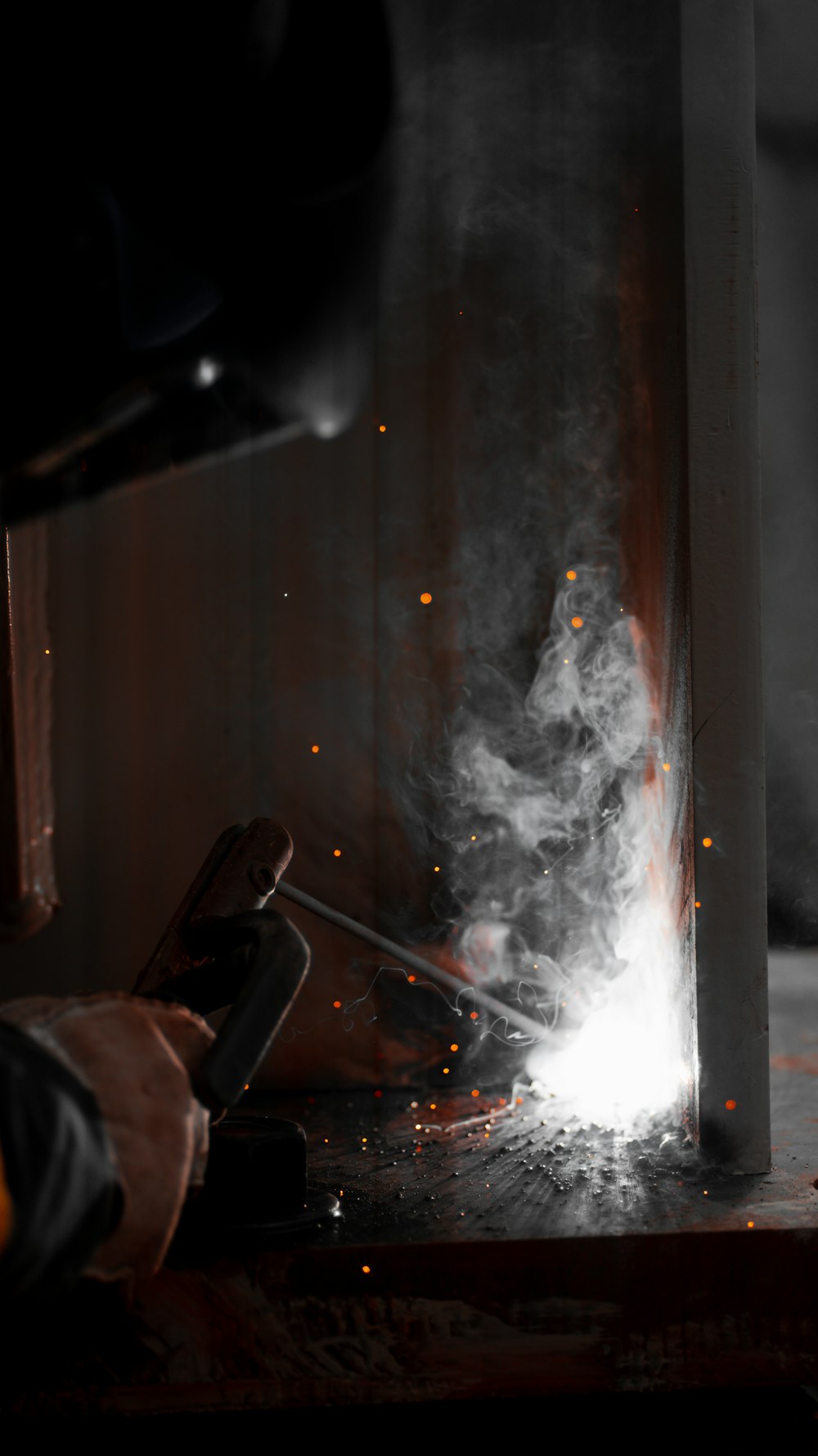 welder working on a piece of metal in a factory