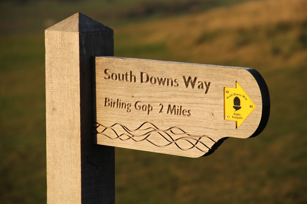 a wooden sign that says south downs way