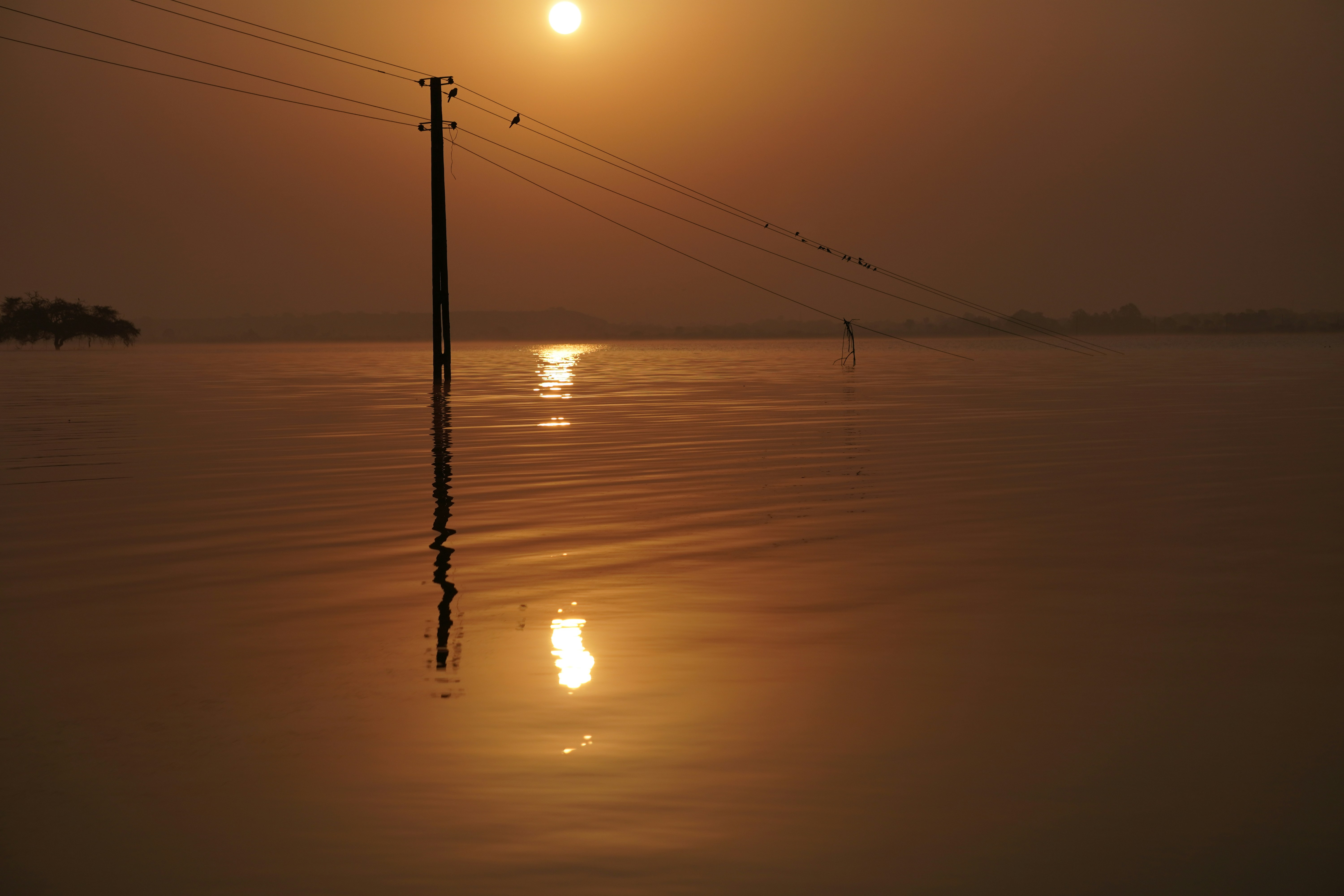 the sun is setting over a body of water