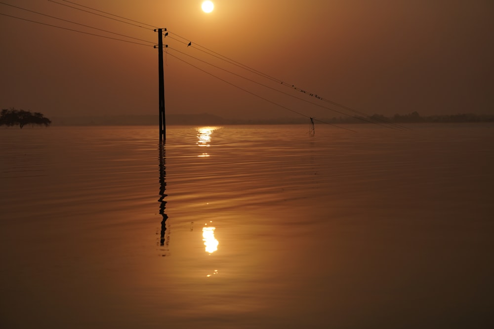 the sun is setting over a body of water