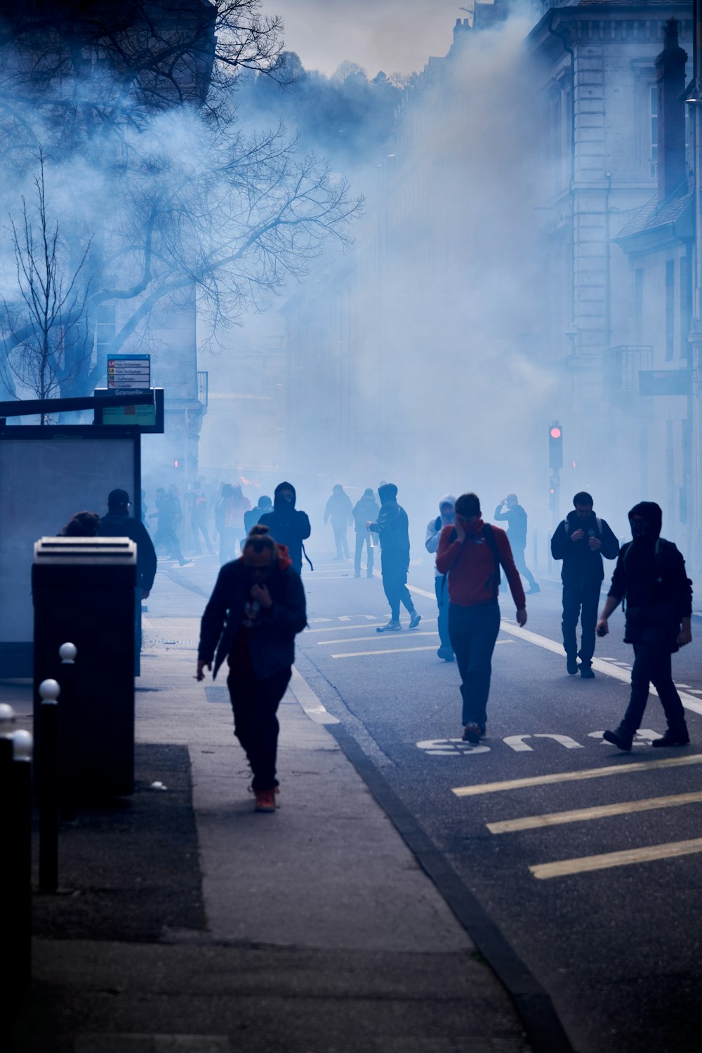 a group of people walking across a street