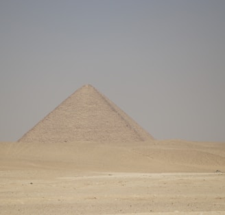 a very tall pyramid in the middle of a desert