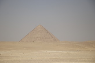 a very tall pyramid in the middle of a desert