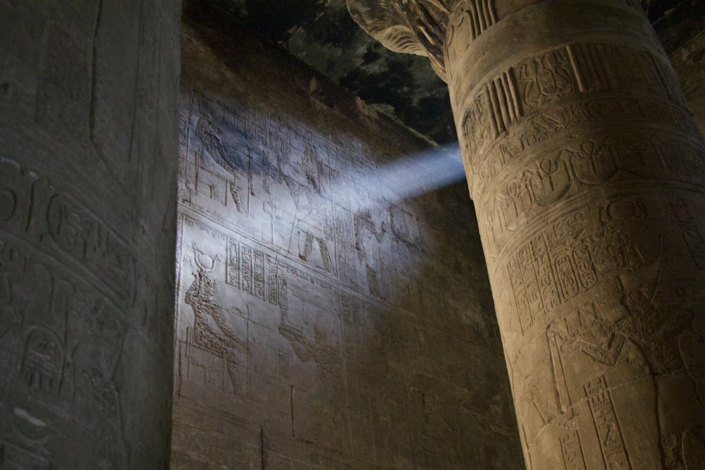 a light shines on the wall of a temple