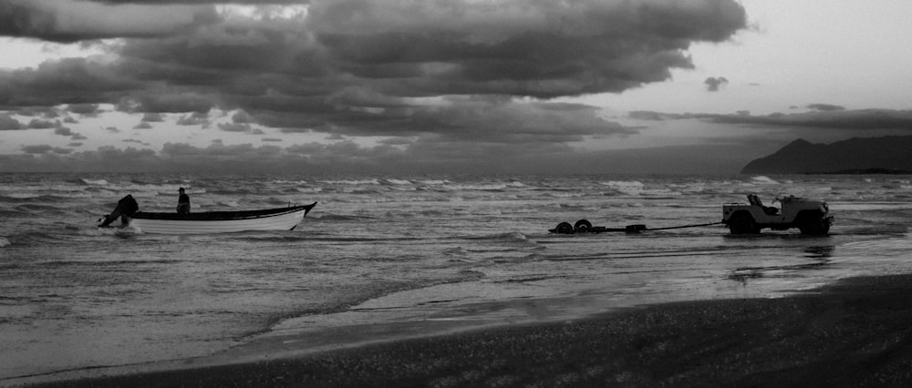 a black and white photo of a boat in the ocean