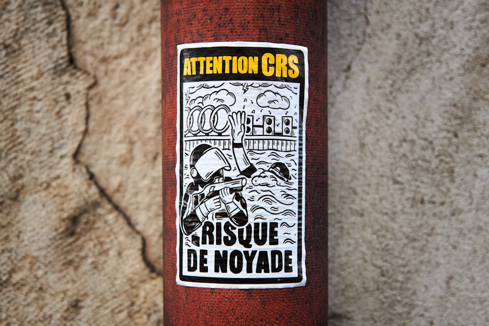 a sticker on the side of a red fire hydrant