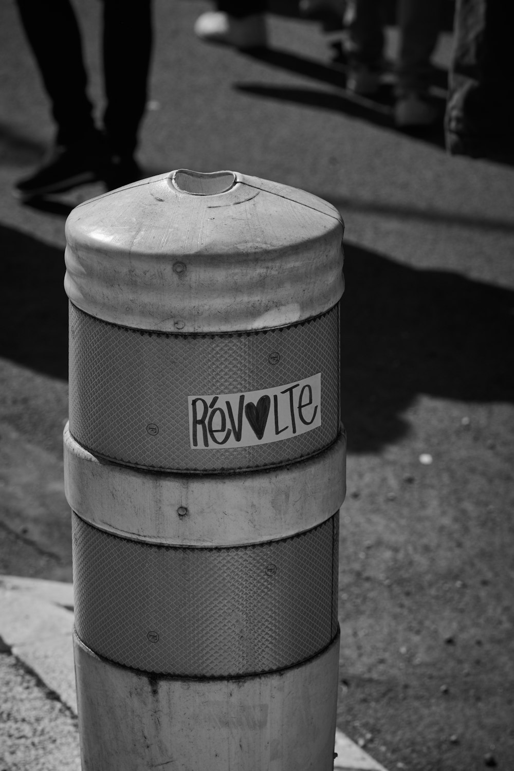 a black and white photo of a trash can