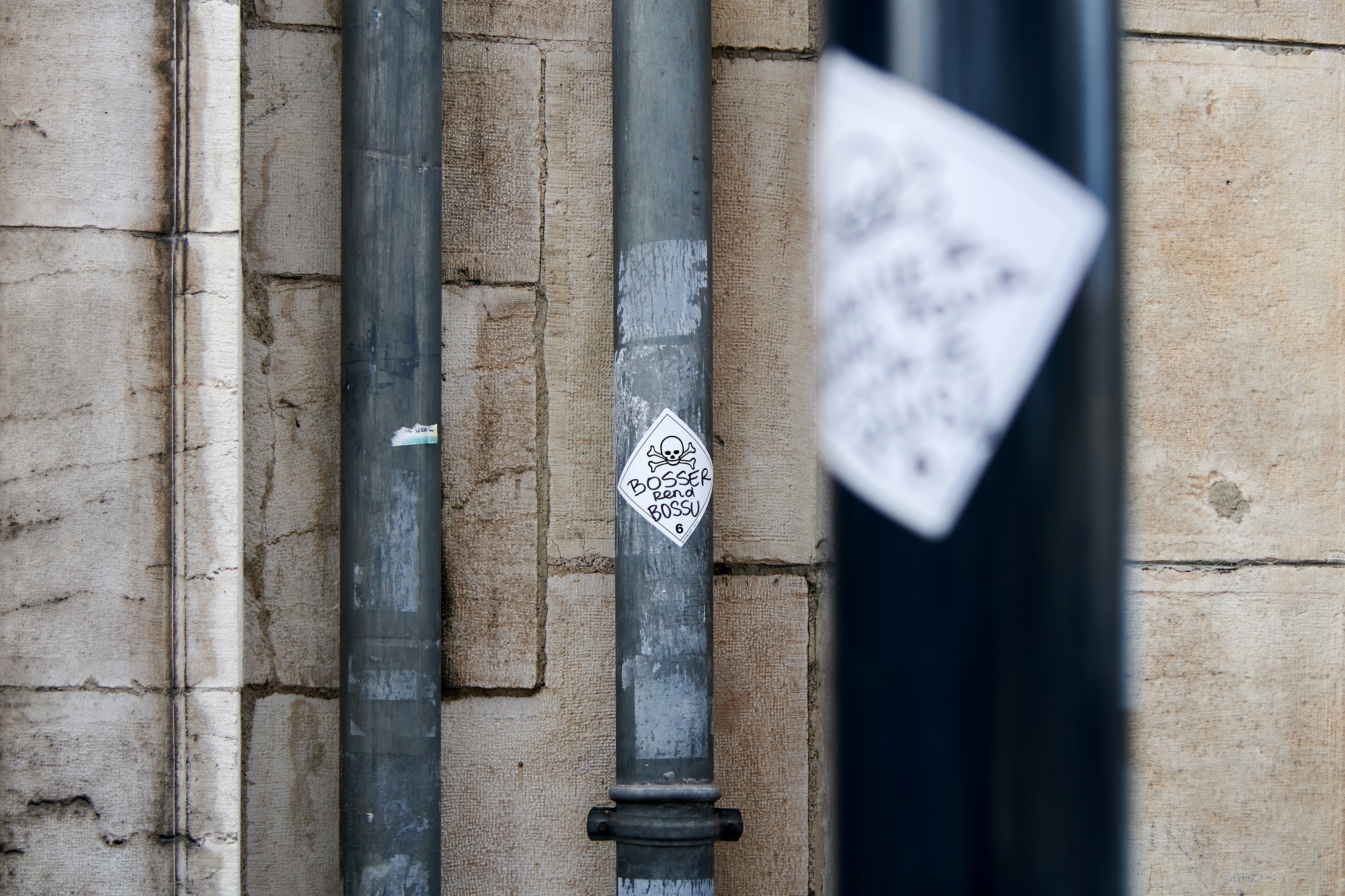 a pole with a sign on it next to a building