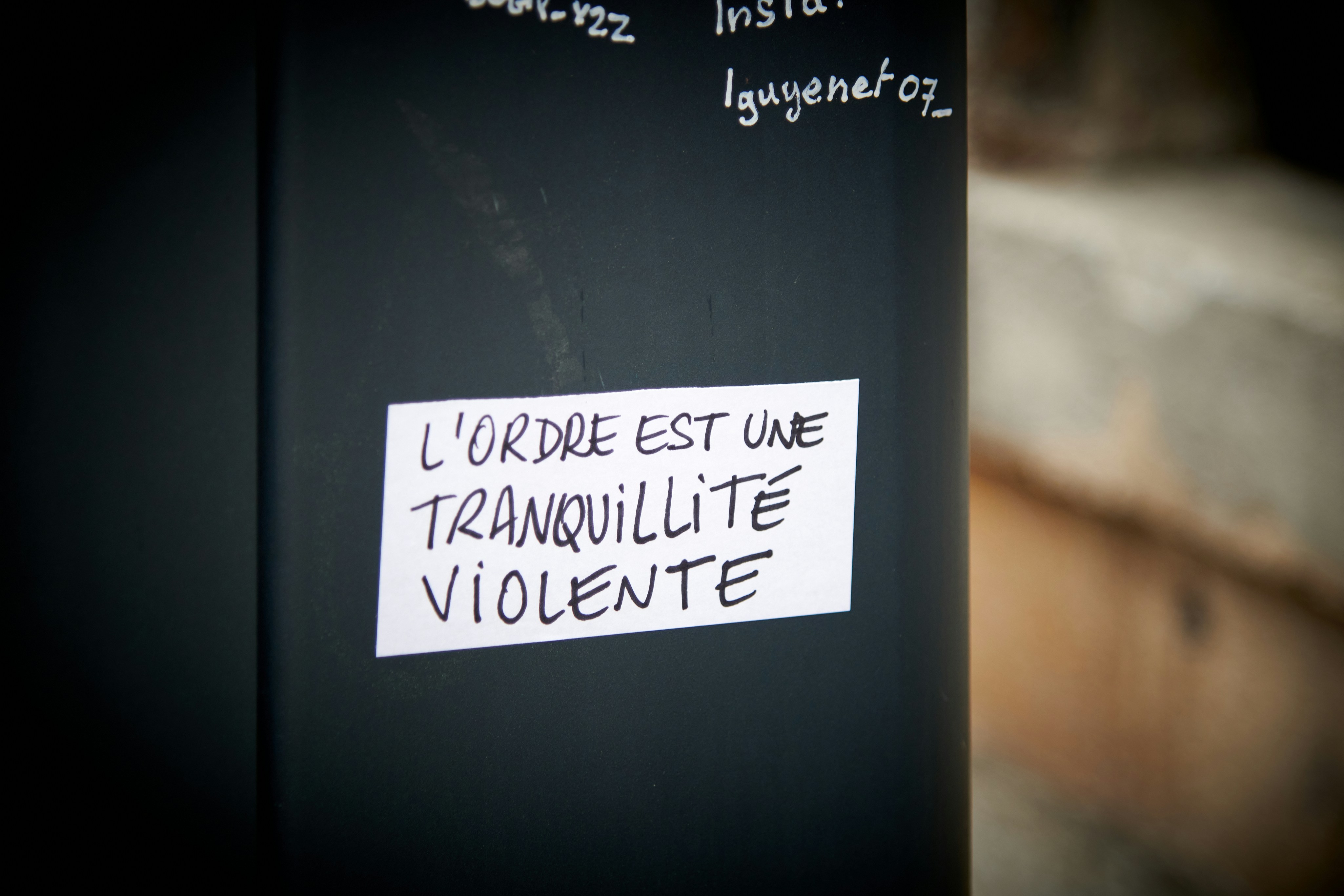 a black refrigerator with a white sticker on it