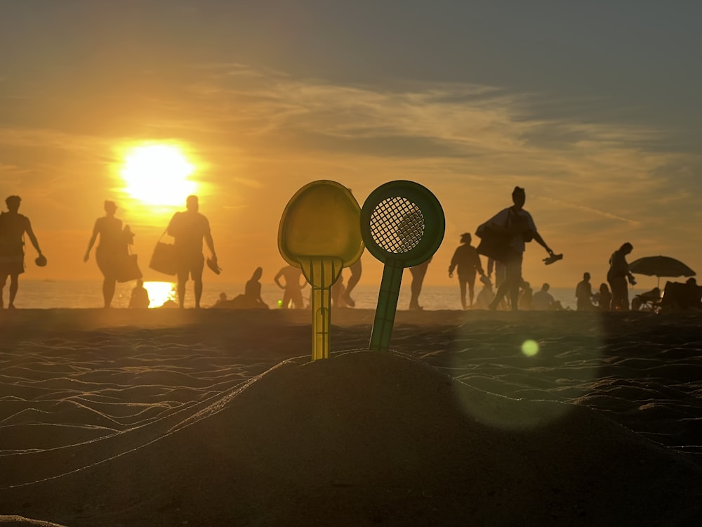 a group of people standing on top of a sandy beach