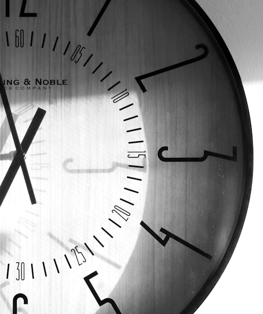 a black and white photo of a clock