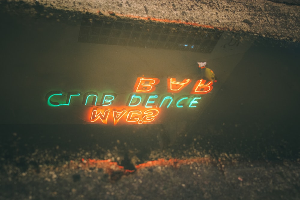 a neon sign on the side of a road