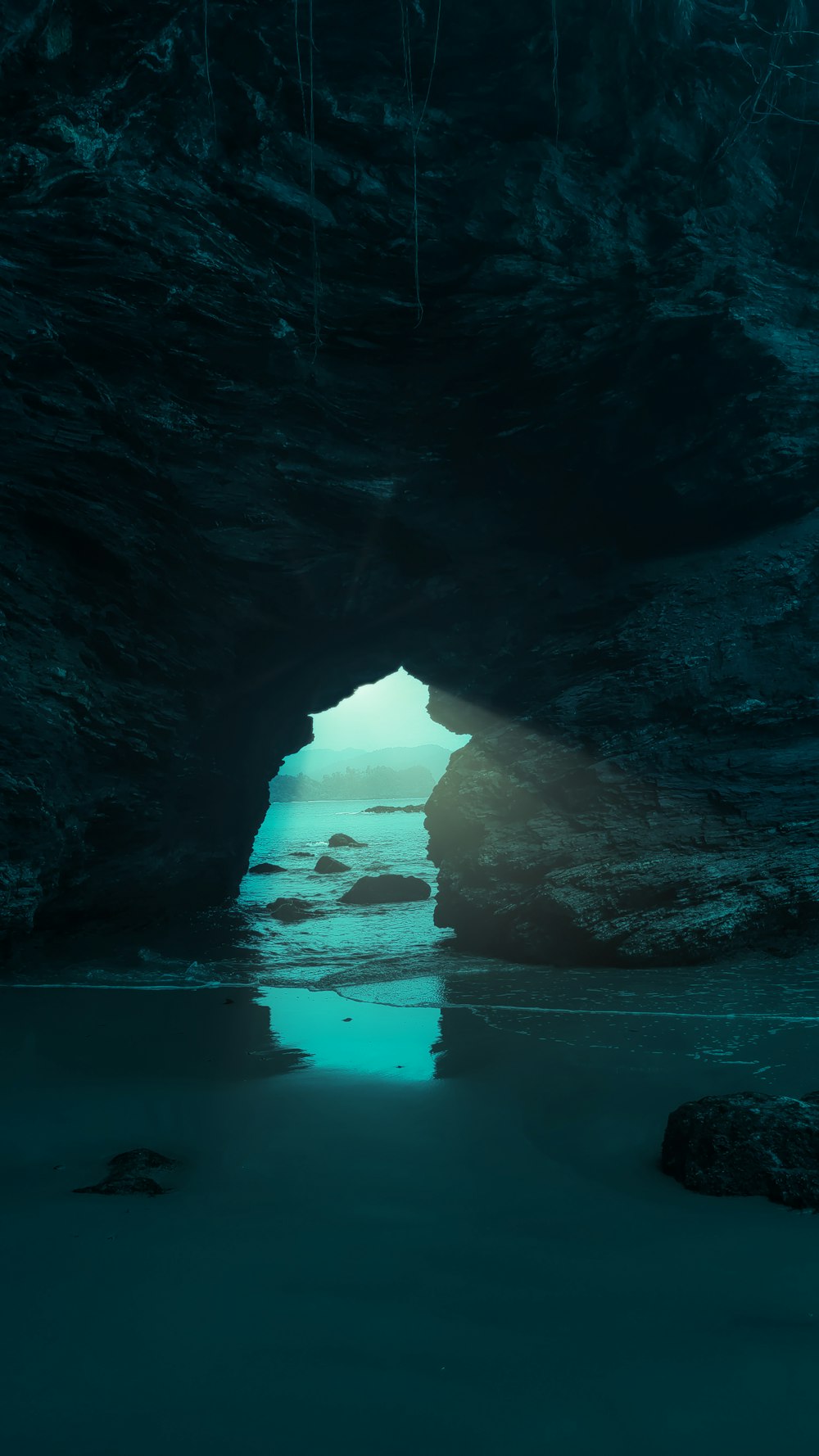 a dark cave with a light at the end of it