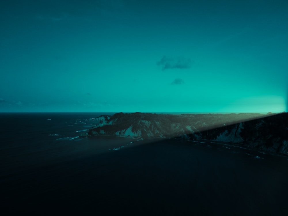 a view of the ocean from the top of a hill