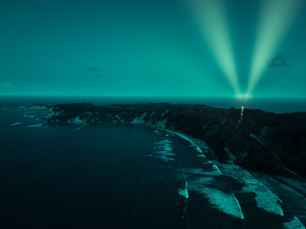 a green light shines over a large body of water