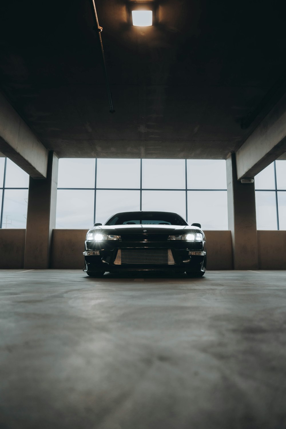 a black car parked in a parking garage