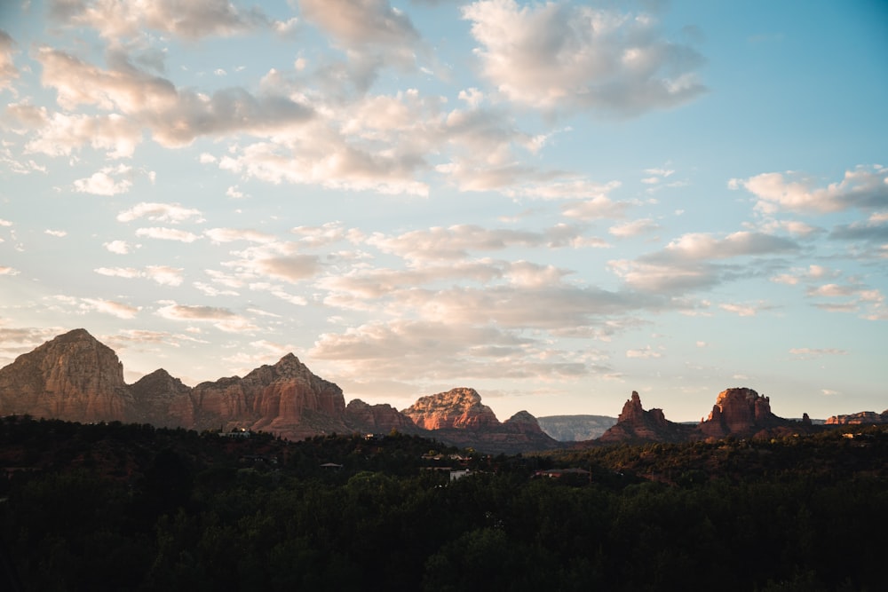 a view of a mountain range with clouds in the sky