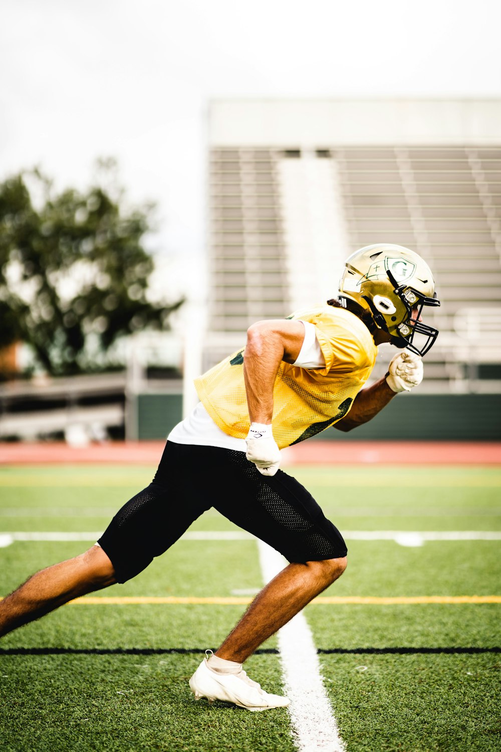 a man in a football uniform running on a field