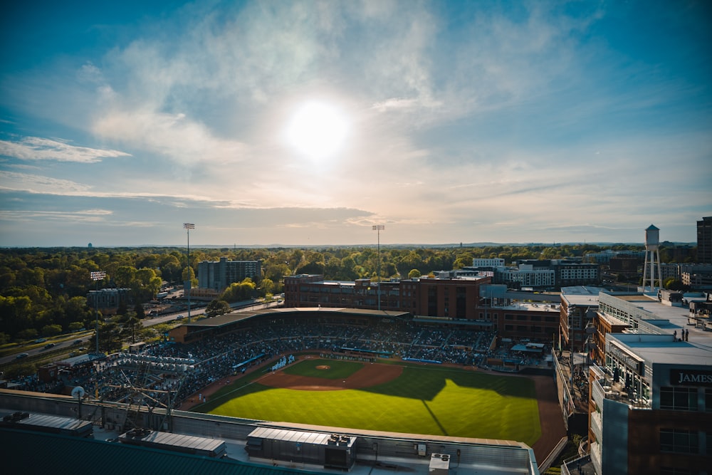 an aerial view of a baseball field with the sun in the background