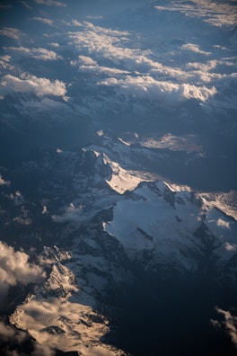 Mountain peaks under soft clouds, framed by a drone’s lens.
