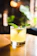 Close-up of a refreshing mojito with mint leaves and lime on a black elegant terrace table.