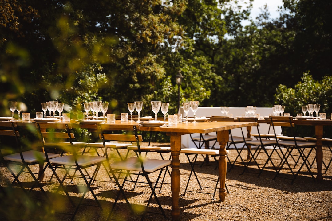 a long table set up with empty wine glasses, Italian evening wedding