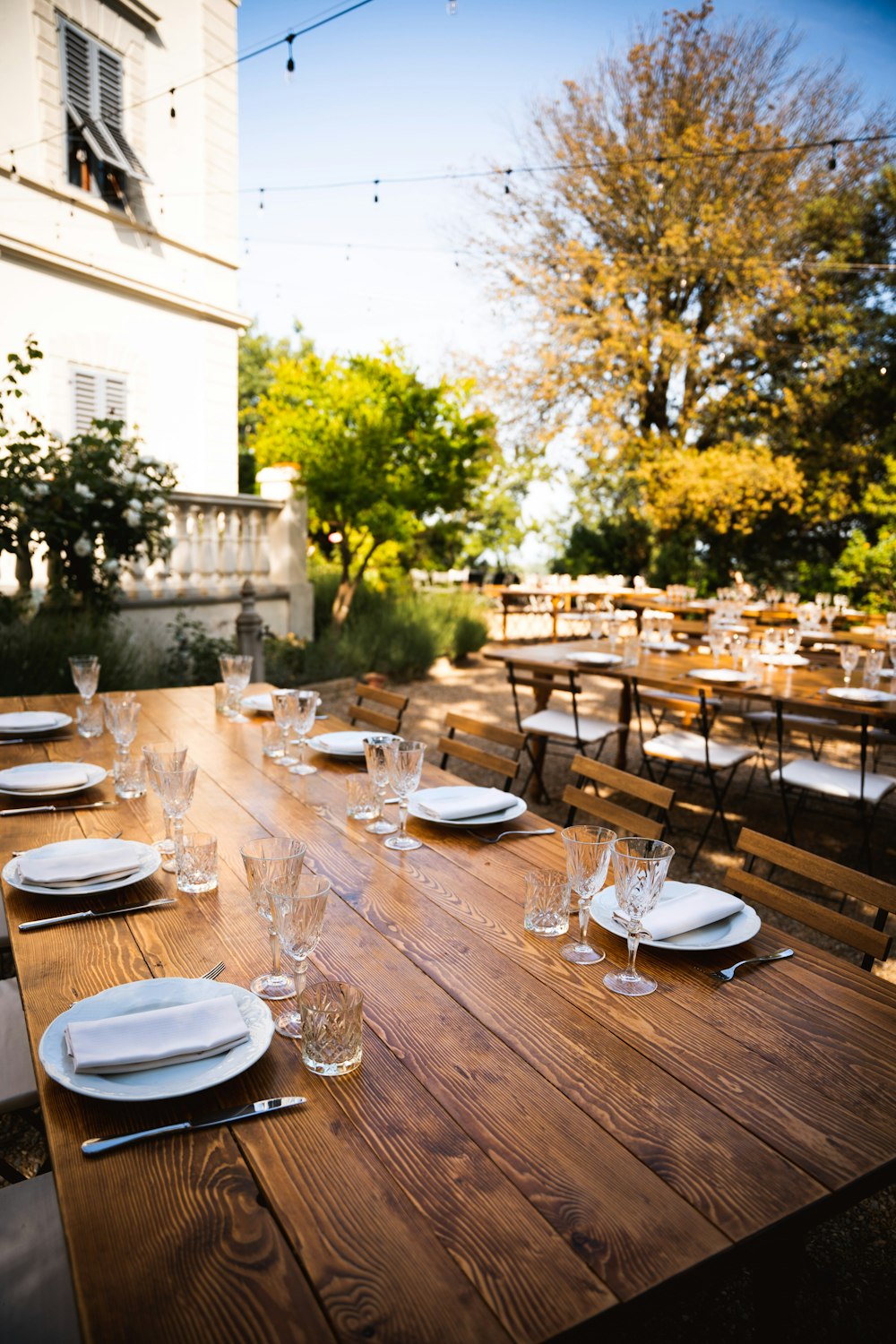 a wooden table with plates and glasses on it