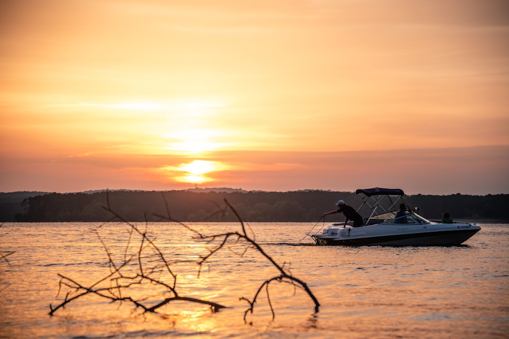 a boat in a body of water at sunset