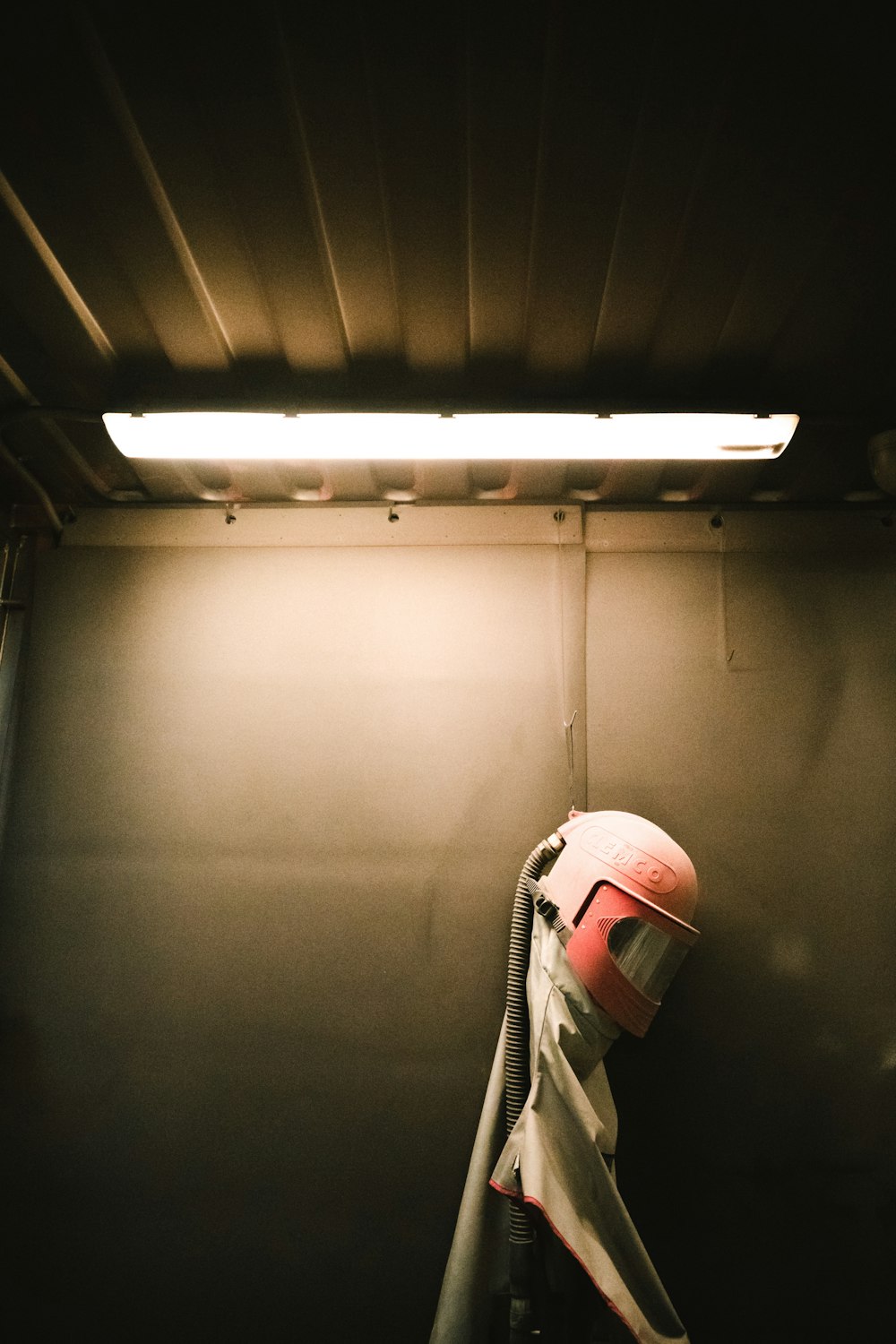 a helmet hanging on a wall in a room