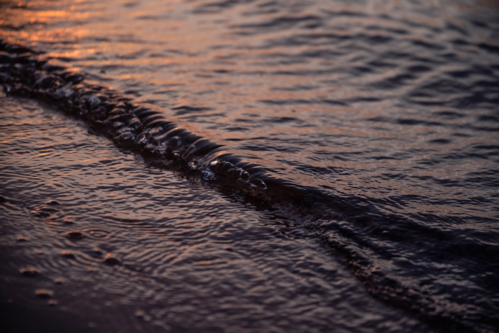 a close up of a wave on a beach