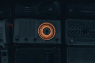 Group of radio DJs smiling while broadcasting live surrounded by vintage radios and Javanese decor.