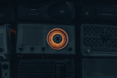 Close-up of retro radio dials and buttons glowing softly in a cozy room.