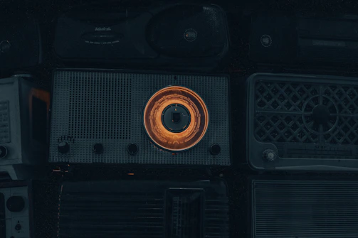 A collection of restored vintage radios and appliances arranged neatly on a workbench.