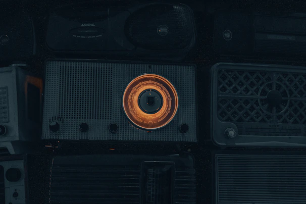 Veteran hams gathered around radios during a lively contest, their faces lit by the glow of equipment.