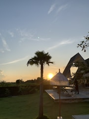A sleek motorized awning extending over a modern outdoor patio during sunset.
