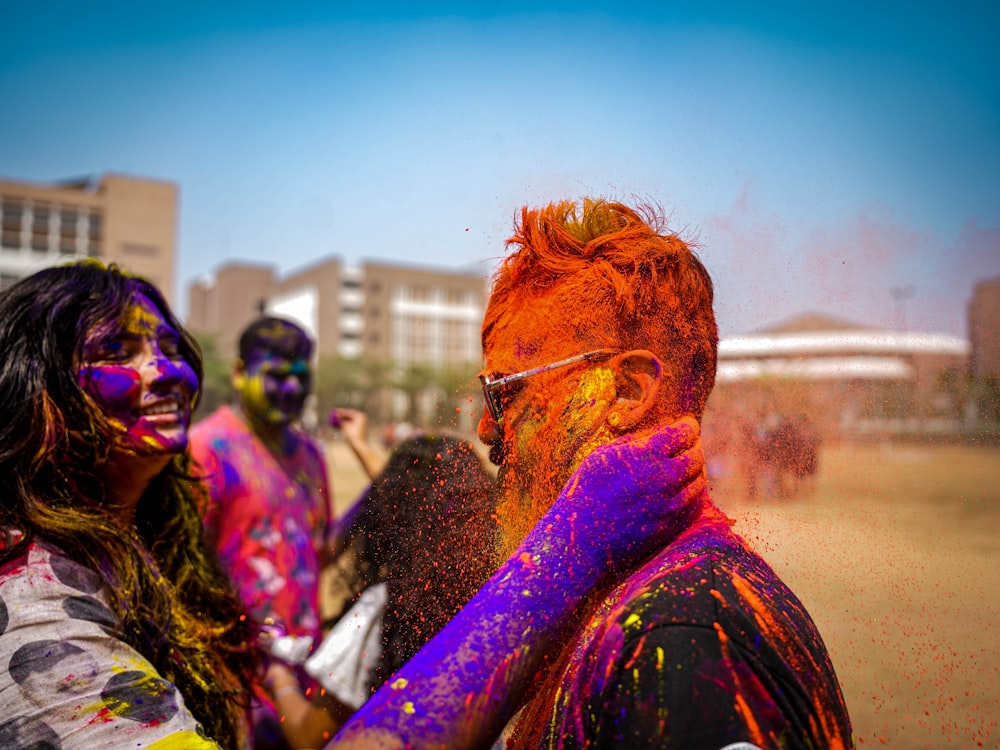 a group of people covered in colored powder