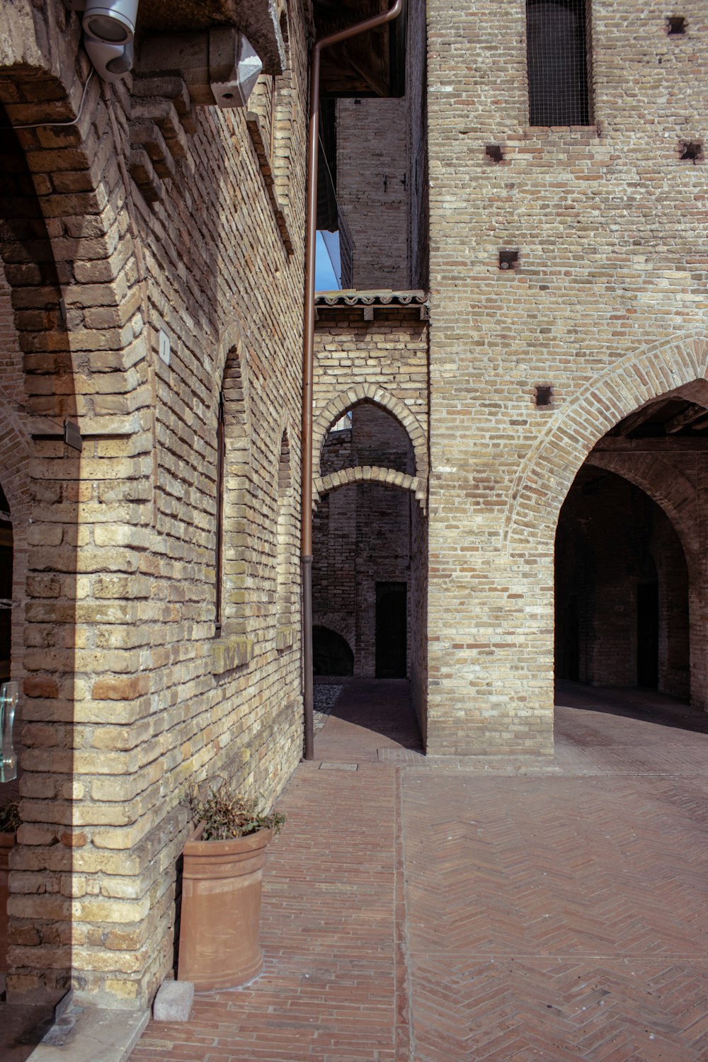 a brick building with arches and a clock tower