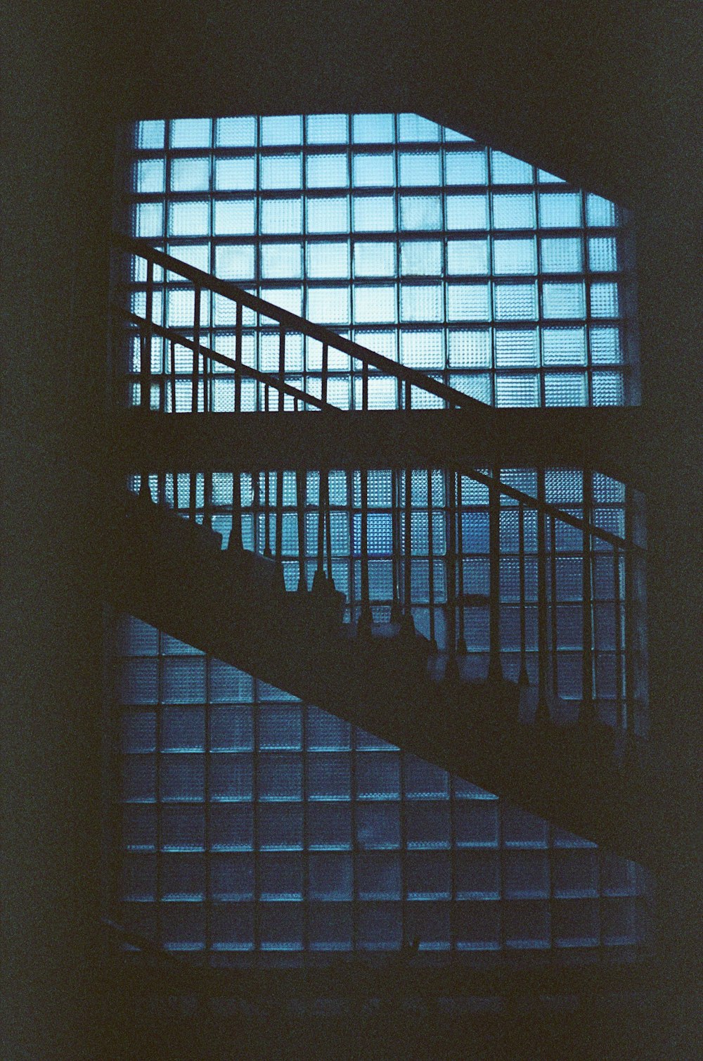 a stair case in front of a window at night