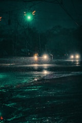 A cinematic scene with dim city lights reflecting on rain-soaked streets at night