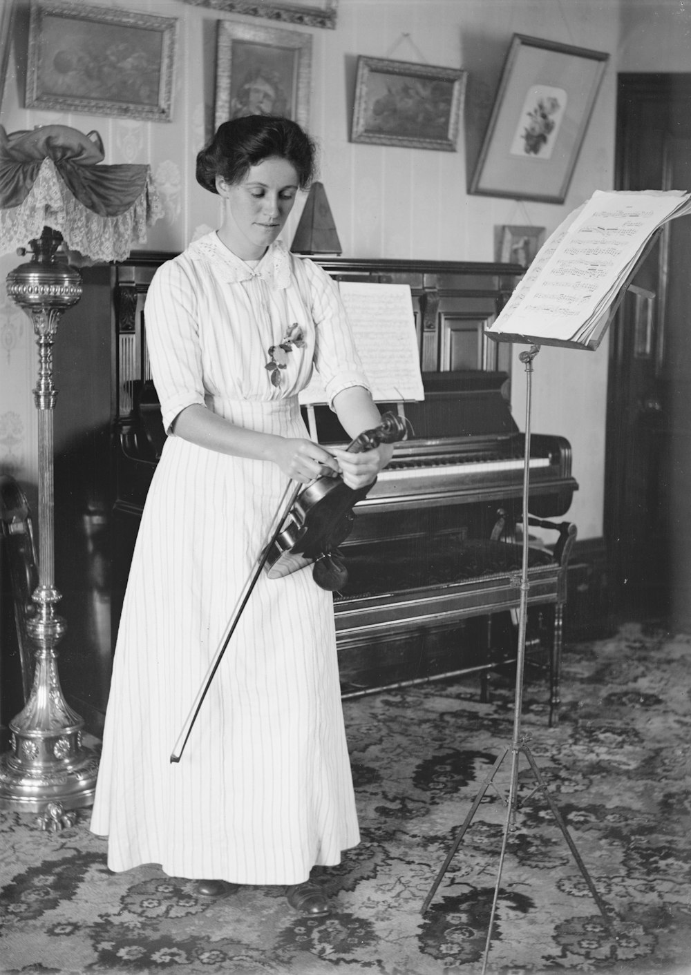 a woman standing in front of a piano