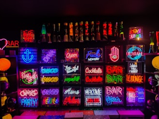 A collection of custom neon signs displayed at an event.